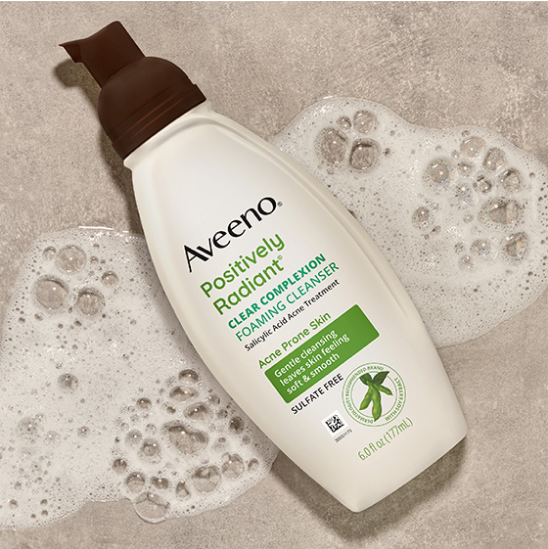 Image of Aveeno Positively Radiant Clear Complextion Foaming Cleanser Bottle with cleanser suds.