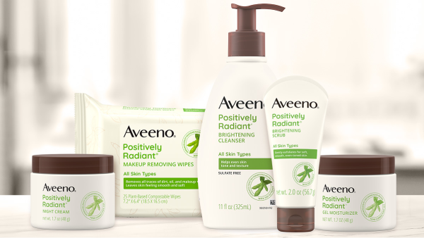 Image of woman washing her face with Aveeno Cleanser wash.