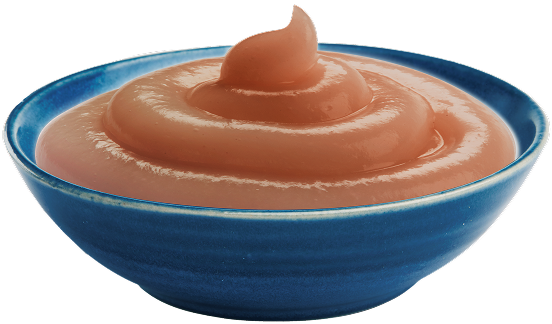 A blue bowl of Tastefuls Purées is next to a sprig of orange flowers.