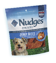 Blue Buffalo dog food treats under a festive banner.