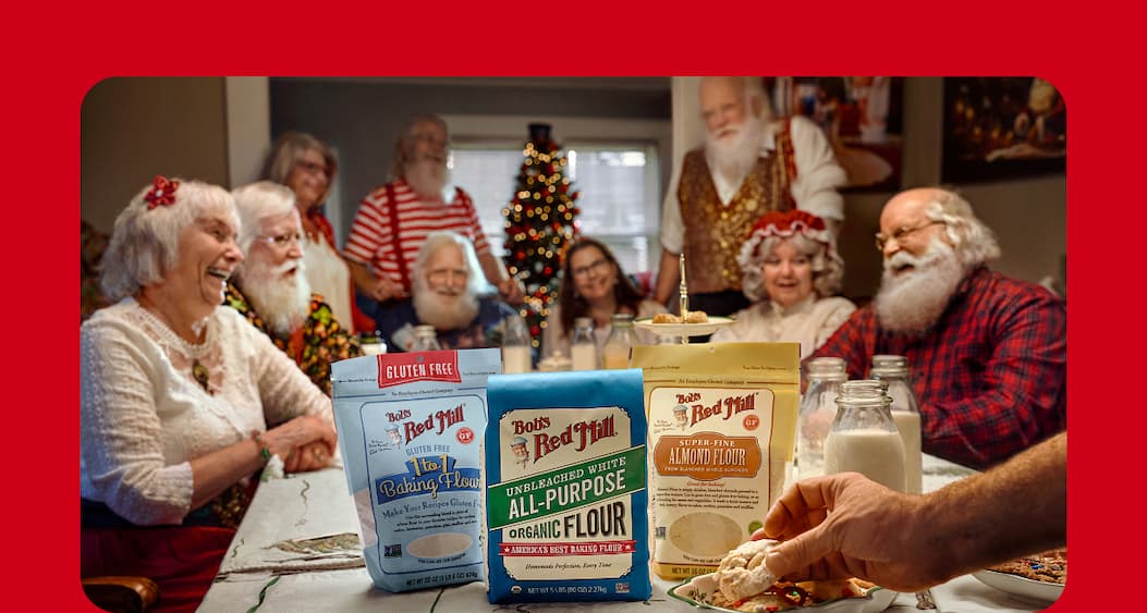 Moregetherness. Image of Santa and Mrs. Claus at a holiday table featuring Bob's Red Mill Gluten Free 1-to-1 Baking Flour, Organic All-Purpose Flour and Almond Flour