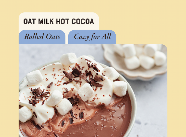 Cup of decadent Oat Milk Hot Cocoa topped with mini marshmallows and chocolate shavings