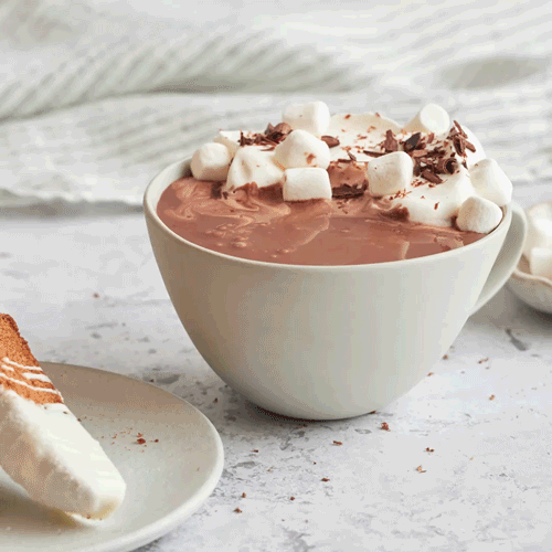 Gif of gingerbread biscotti being dipped into a mug of Oat Milk Hot Cocoa