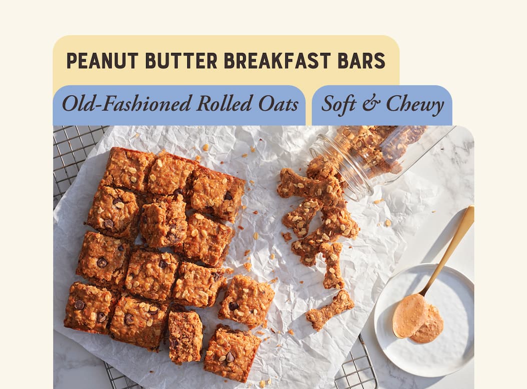 Peanut Butter Breakfast Bars. Image of oat, fruit and seed oatmeal bars sliced into squares.