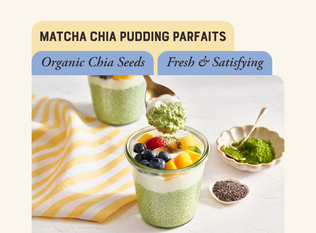 Matcha Chia Pudding Parfaits. Image of jar filled with light green matcha chia pudding topped with whipped cream and fresh fruit
