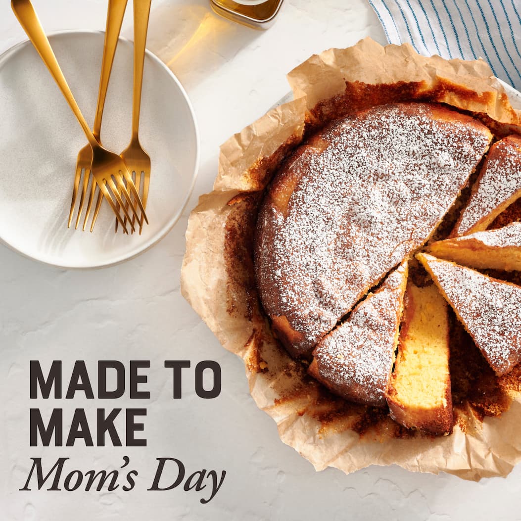 Made to Make Mom's Day. Image of Almond Olive Oil Cake sliced with powdered sugar on top.