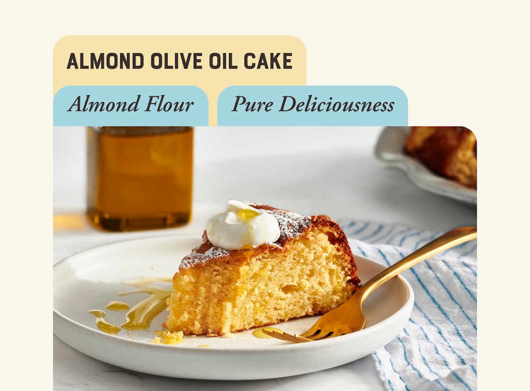 Almond Olive Oil Cake. Image of slice of almond olive oil cake topped with whipped cream.
