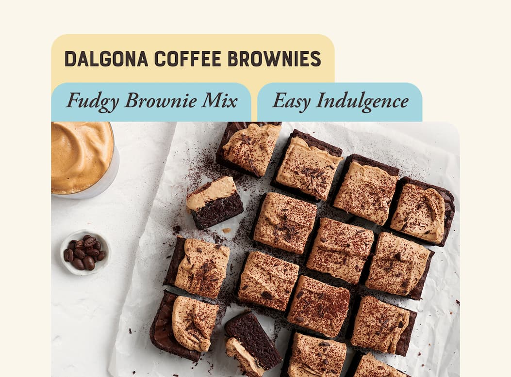 Dalgona Coffee Brownies. Brownies sliced into squares and topped with fluffy dalgona coffee frosting and dusted in cocoa.