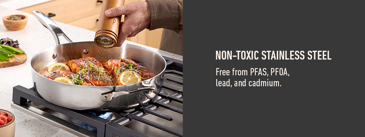 Non-toxic stainless steel pan with chicken and lemon slices on a stove, text highlights it is free from PFAS, PFOA, lead, and cadmium.