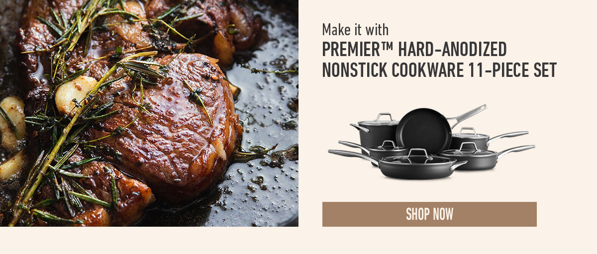 Cooked steak with herbs beside a display of black nonstick cookware set. Text promotes Premier hard-anodized nonstick cookware 11-piece set. Shop now button.