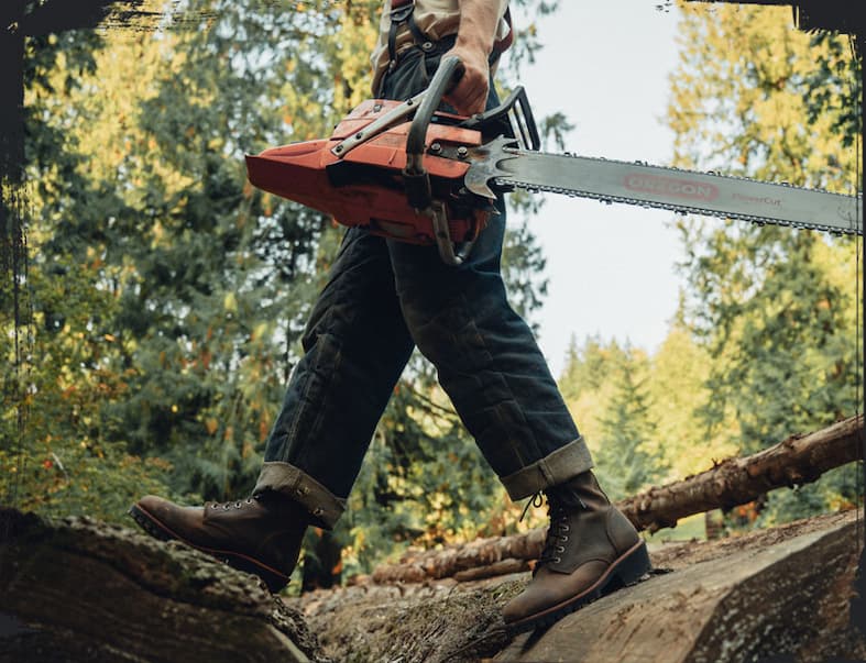 A man wearing the Classic 2.0 8" Logger in chocolate apache (brown).