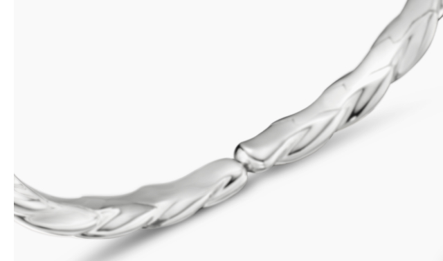 A sculptural silver bangle that catches the light just right. Shop Now