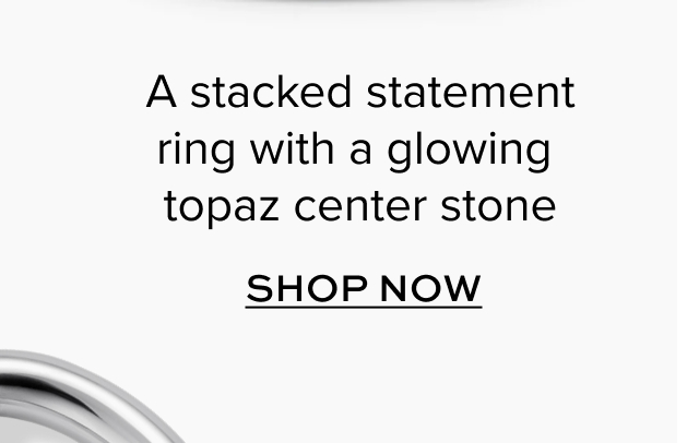 A stacked statement ring with a glowing topaz center stone