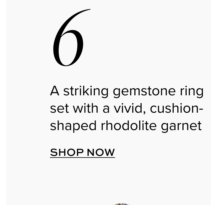 A striking gemstone ring set with a vivid, cushion-shaped rhodolite garnet