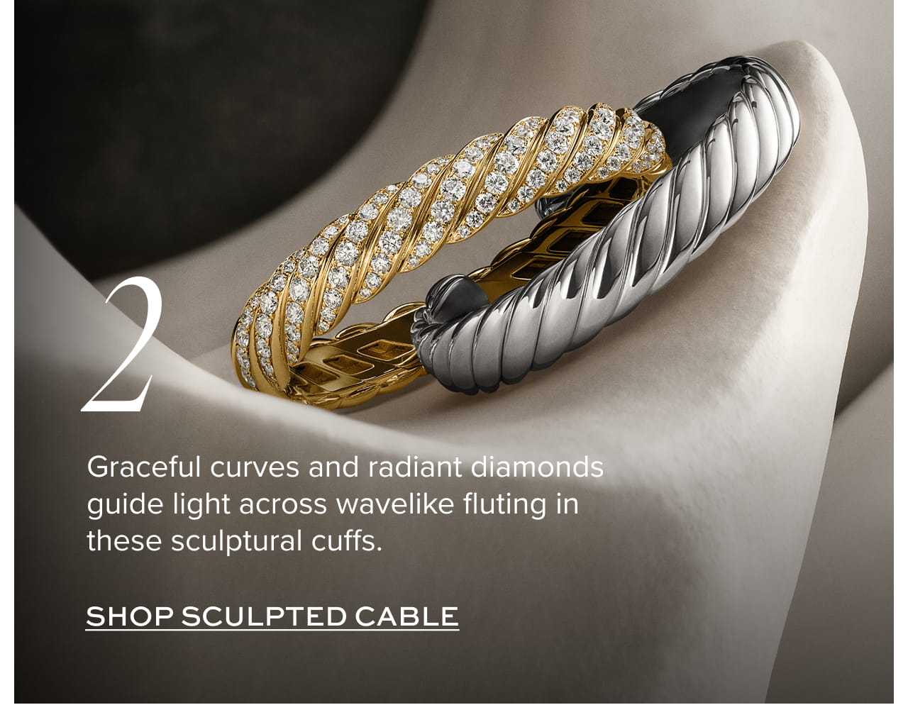 Graceful curves and radiant diamonds guide light across wavelike fluting in these sculptural cuffs.