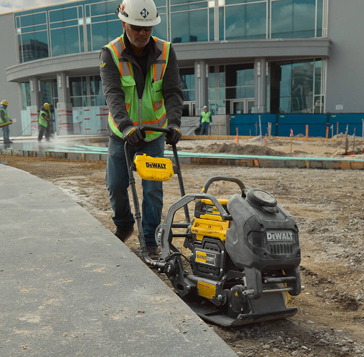 DEWALT POWERSHIFT™ plate compactor compacting dirt on jobsite