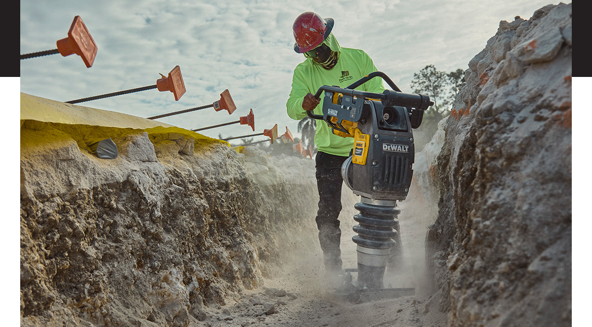 DEWALT POWERSHIFT™ rammer compacting sand in trench