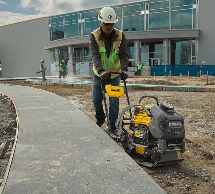 DEWALT POWERSHIFT™ plate compactor compacting dirt on jobsite