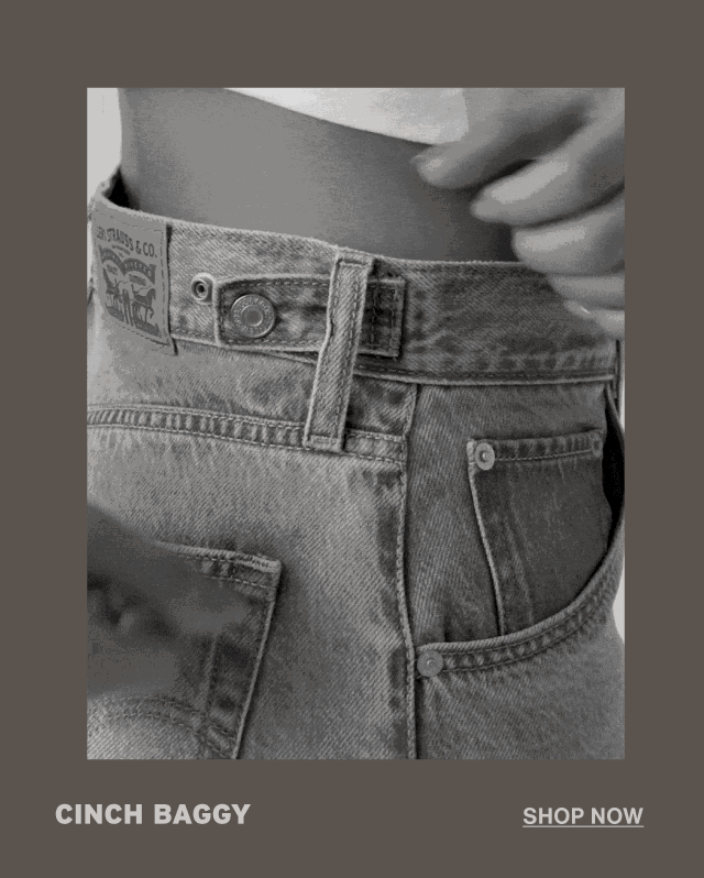 Person cinching their jeans.
