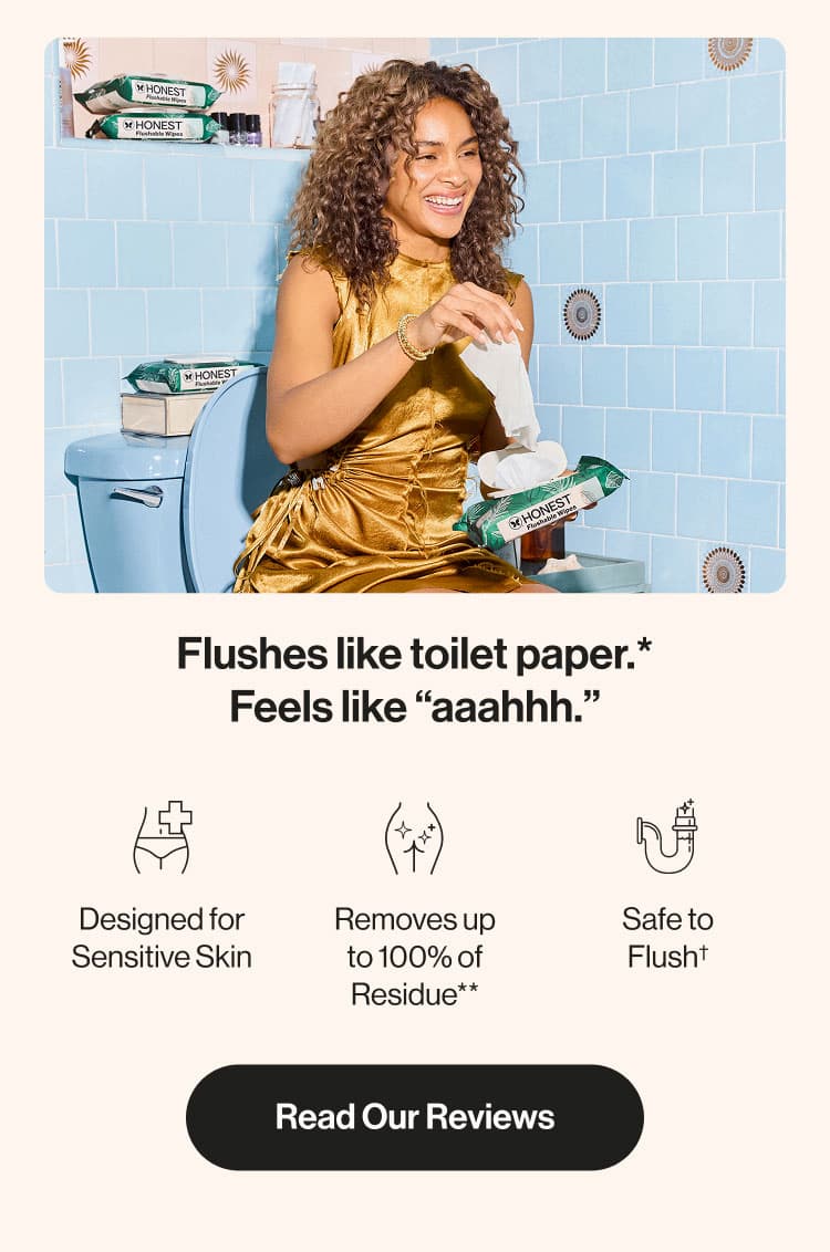 Woman sitting on toilet pulling flushable wipes out of the package