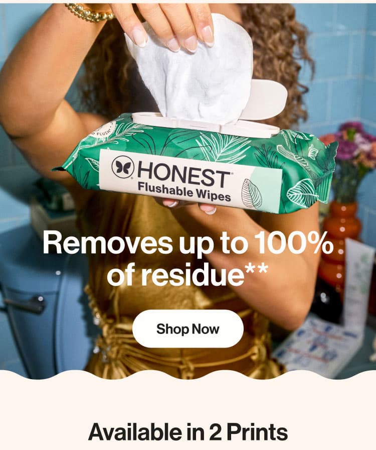 Woman sitting on toilet pulling flushable wipes out of the package