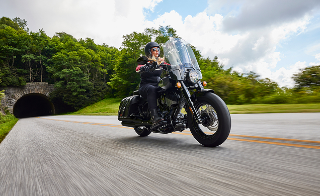 Indian Motorcycle Rider driving through a stone arch tunnel