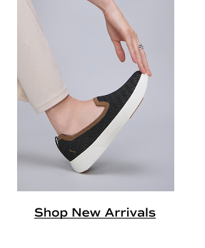 The BlissWalk Knit Loafer in black/cognac shown on foot paired with light tan pants. Shop New Arrivals.