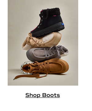 A stack of four Explore Suede Booties in varying colors. Shop boots.
