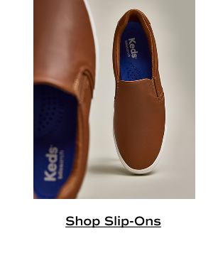 A pair of Pursuit Leather Slip-Ons in cognac brown. Shop slip-Ons.