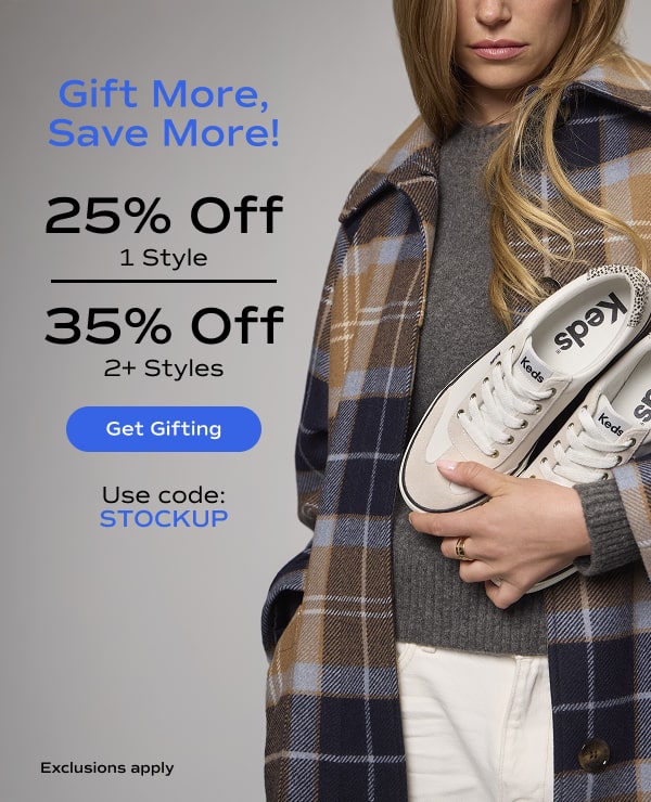 A woman in a grey sweater and plaid jacket holding a pair of Jump Kick T-Toe Leather/Suede Hair Calf Heel Lace-Ups in off white/beige. The email says Gift More, Save More! 25% Off 1 style, 35% Off 2 or more styles. Exclusions apply. Use code: STOCKUP. Get Gifting.