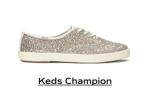 A side view of the Keds Champion Glitter Celebrations Lace-Up in gold. Shop Keds Champion.