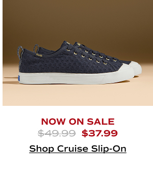 A side view of the Cruise Mini Daisy Eyelet Slip-Ons in navy which were $49.99 and are now on sale for $37.99. Shop Now.