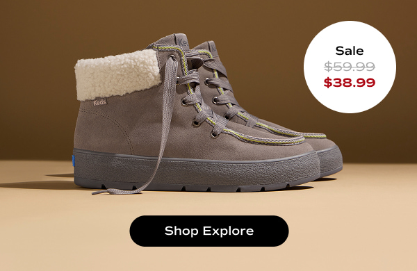 A brown background with a side view of the Explore Bootie Suede Pop Binding in grey. The style was $59.99 and is now $38.99 for a limited time. Shop Explore.
