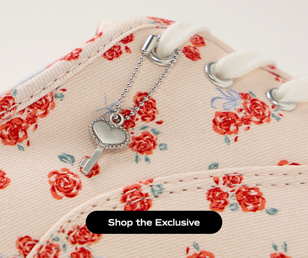 A close-up on the Keds Champion Canvas Lace-Up in exclusive floral print. The image is animated showing the heart-shaped key shoelace charm swinging back and forth. Shop the Exclusive.