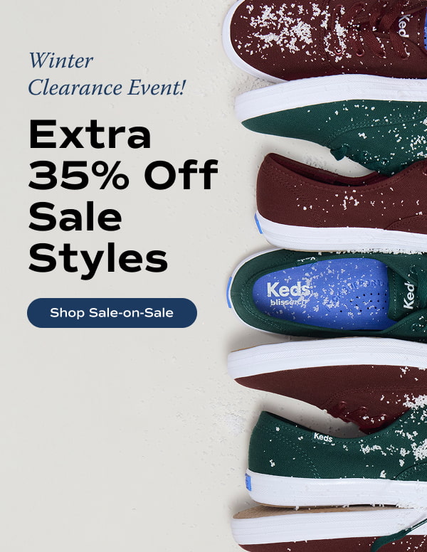 Multiple pairs of the Keds Champion Canvas Lace-Ups lined up in a vertical row on the right side. The sneakers interchange colors—burgundy and forest green—and are sprinkled with a light dusting of snow. Text to the left of the sneakers says Winter Clearance Event! Extra 35% Off Sale Styles. Shop Sale-on-Sale.
