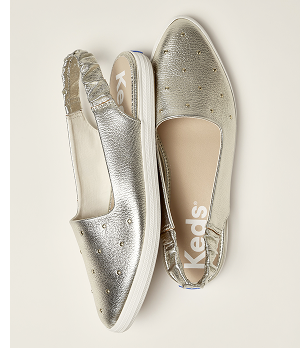 A top-down view of a pair of Point Slingback Leather Studs in gold metallic.