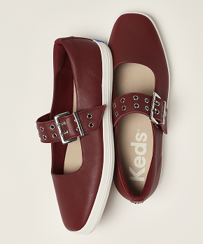 A top-down view of a pair of Square Toe Mary Jane Leather Grommet Buckle flats in red.
