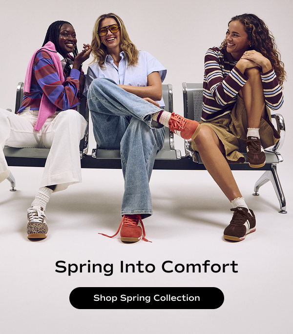 Three smiling women sitting on a bench each wearing a different color of the Revival Suede Lace-Ups paired with causal, on-trend outfits. Text on the image says Spring Into Comfort. Shop Spring Collection.