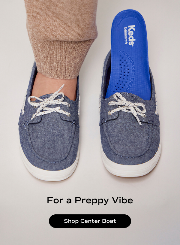 An overhead view of a woman wearing knit brown pants stepping into the Center III Boat Chambray Slip-On in blue featuring a BlissArch footbed. The text says For a Preppy Vibe. Shop Center Boat.