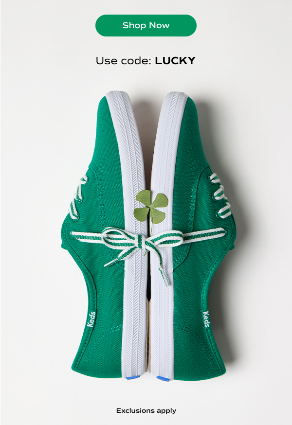 A pair of Keds Champion Canvas Lace-Ups in green positioned sole-to-sole with their laces tied together in a bow and a green four-leaf clover sitting on their outsoles. Text above and below the sneakers says Use code: LUCKY. Exclusions apply. Shop Now.