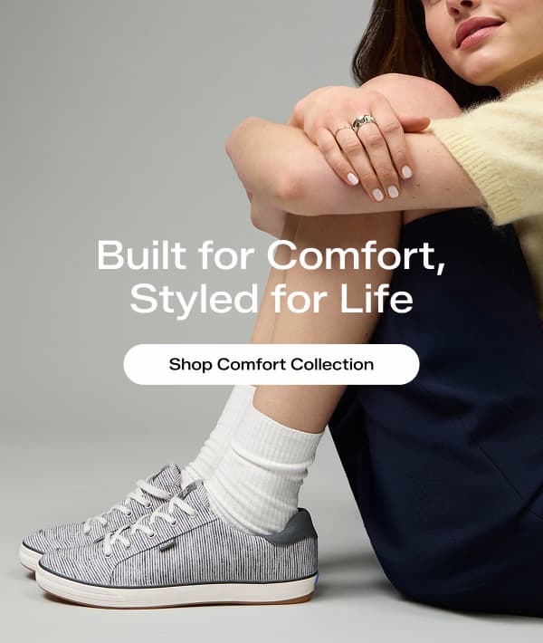 A woman sitting wearing a soft yellow sweater, long navy shorts, and the Center III Stripe Textile Lace-Up in dark grey/snow white. The email says Built for Comfort, Styled for Life. Shop Comfort Collection.