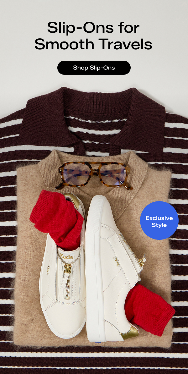 A ready-to-pack outfit arrangement featuring a striped collared top, camel-colored collared sweater, tortoiseshell-pattern glasses, and the exclusive Pursuit Zip Leather Metallic Heel in snow white/gold with red socks tucked into the shoes. The email says Slip-Ons for Smooth Travels. Shop Slip-Ons.