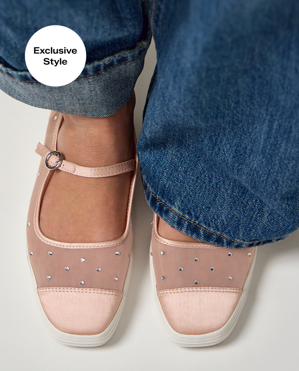A top-down view of the Square Toe Mary Jane Sheer Mesh Jewels flats shown on foot paired with wide-leg jeans. A callout on the image notes that this style is a Keds.com exclusive.