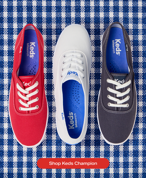 A blue-and-white gingham background with three pairs of the Keds Champion Originals Lace-Ups in red, white, and blue facing alternating directions. Shop Now.