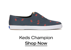 A side view of the Keds Champion Round Toe Nautical Canvas Slip-On in navy/red lobster. Shop Now