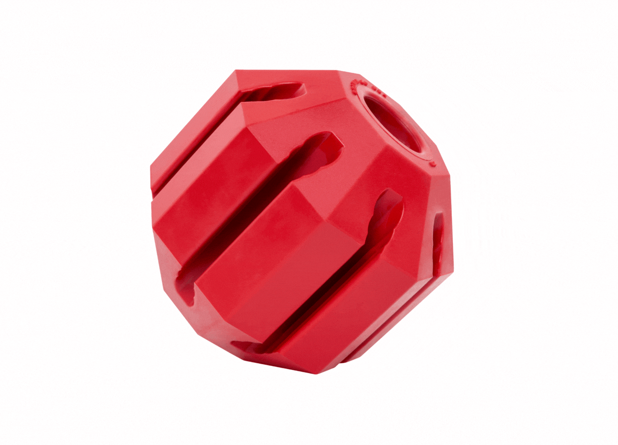 Gif of Stuff-A-Ball with arrows pointing to it that say "durable natural rubber, stuff with treats, and gentle on teeth"