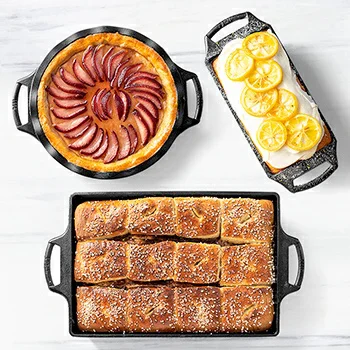 Cast iron bakeware filled with bread, pie, and lemon dessert.