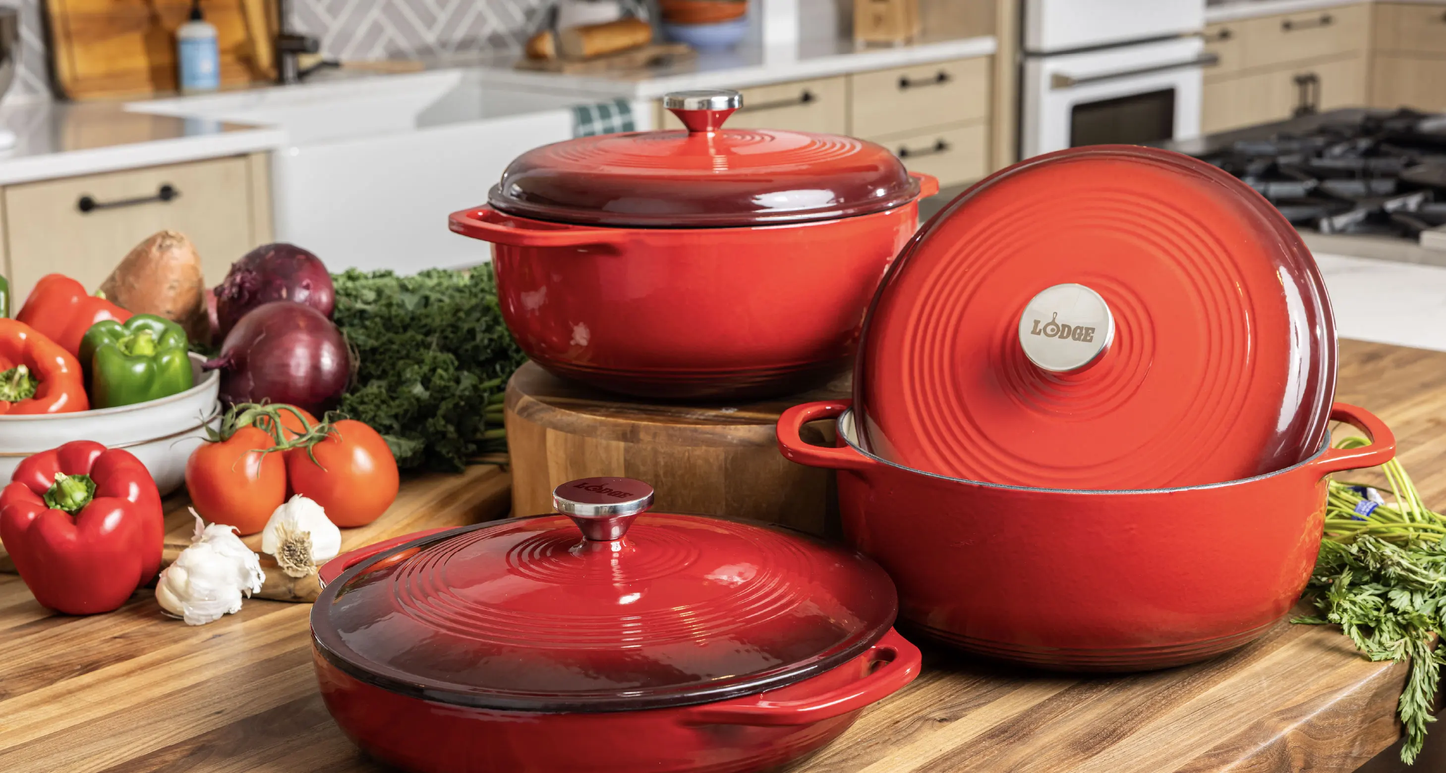 Countertop featuring two red enamel dutch ovens and a red enamel braiser