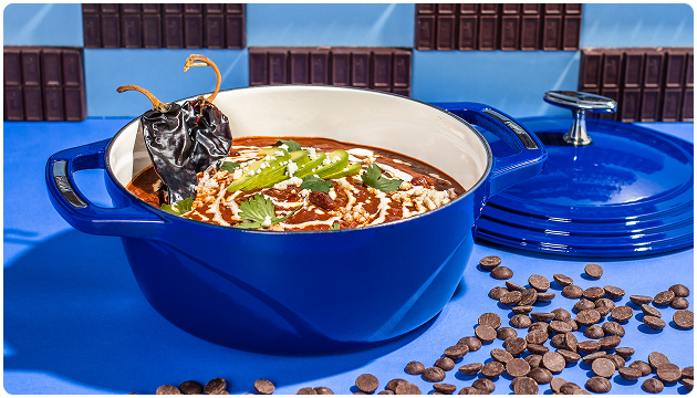 Beautiful dutch oven surrounded by chocolate pieces