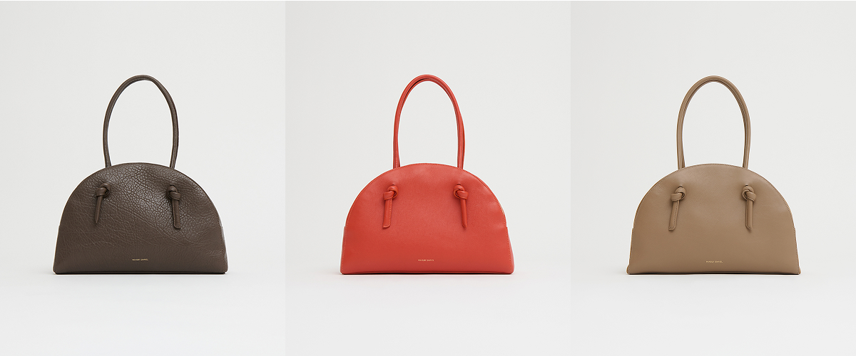 Available in three distinct colorways, crafted in smooth Italian leather with a clean zip-top closure.
